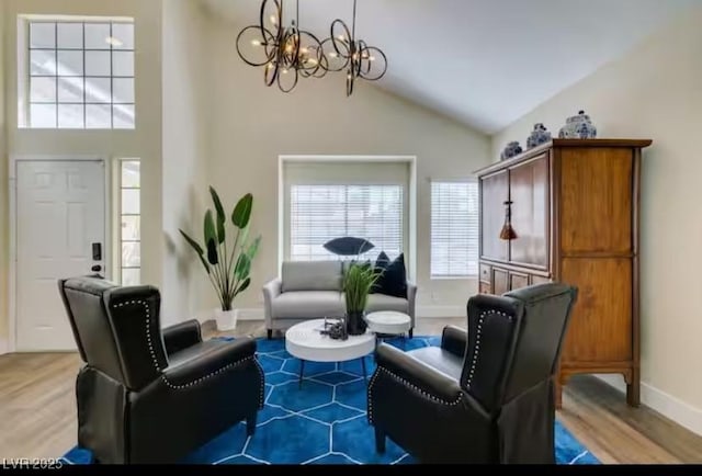 6736 Quinella Dr, Las Vegas, NV 89103 - living area with light wood-style floors, a chandelier, baseboards, and high vaulted ceiling