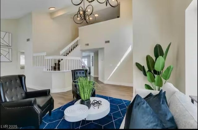 6736 Quinella Dr, Las Vegas, NV 89103 - living room with stairs, a high ceiling, a wealth of natural light, and wood finished floors
