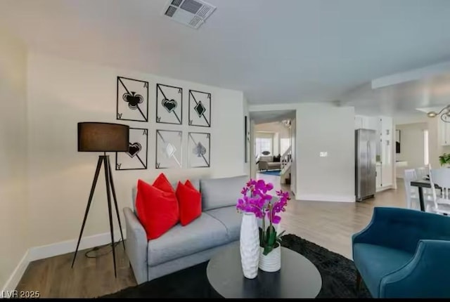 6736 Quinella Dr, Las Vegas, NV 89103 - living area with baseboards, light wood-type flooring, and visible vents