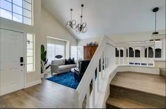 6736 Quinella Dr, Las Vegas, NV 89103 - foyer entrance featuring a chandelier, wood finished floors, and high vaulted ceiling