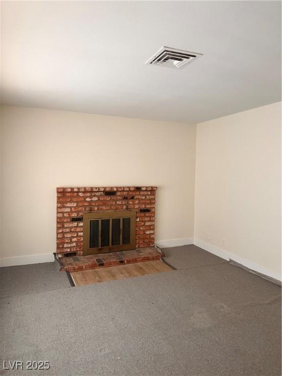 6460 Linda Ln, Las Vegas, NV 89103 - unfurnished living room featuring carpet, visible vents, baseboards, and a brick fireplace