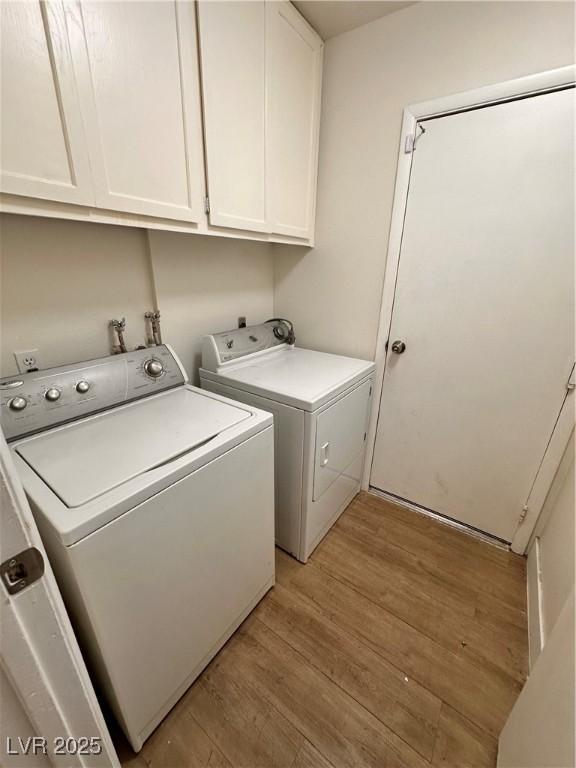 6460 Linda Ln, Las Vegas, NV 89103 - clothes washing area with light wood-style flooring, cabinet space, and washer and clothes dryer
