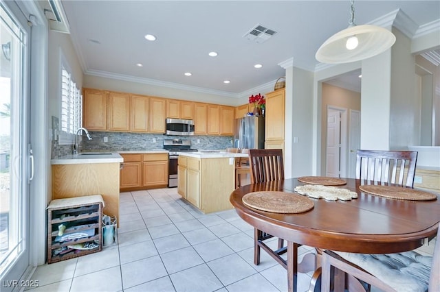 1613 Williamsport St, Henderson, NV 89052 - kitchen featuring stainless steel appliances, light brown cabinets, a sink, light countertops, and ornamental molding