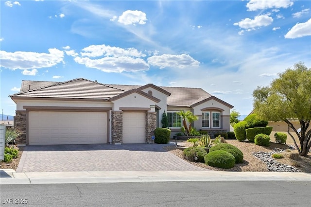1613 Williamsport St, Henderson, NV 89052 - view of front of house featuring stone siding, stucco siding, decorative driveway, and a garage
