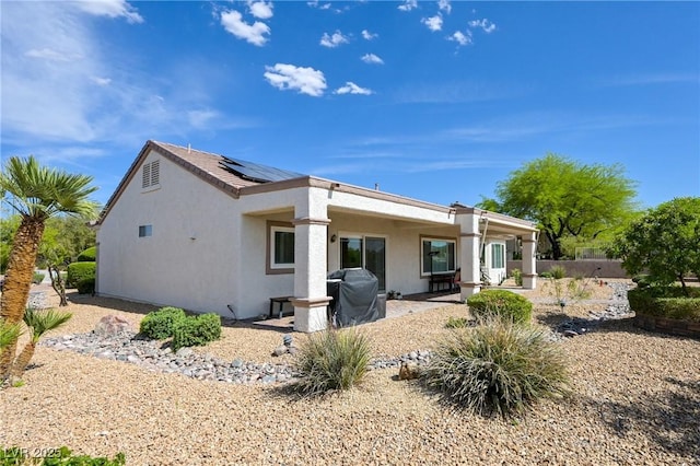 1613 Williamsport St, Henderson, NV 89052 - back of house featuring roof mounted solar panels, stucco siding, and a patio