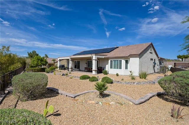 1613 Williamsport St, Henderson, NV 89052 - back of house with solar panels, stucco siding, a fenced backyard, and a patio