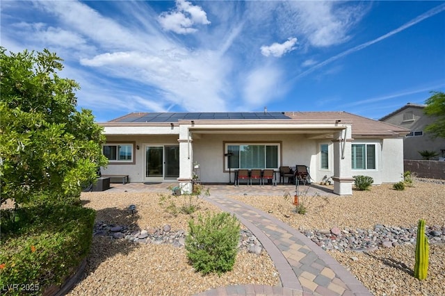 1613 Williamsport St, Henderson, NV 89052 - rear view of house featuring stucco siding, a patio area, and solar panels