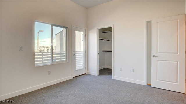 1157 Blossom Point St, Las Vegas, NV 89135 - unfurnished bedroom with a spacious closet, carpet flooring, and baseboards