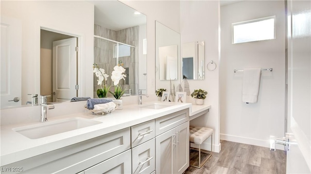 1157 Blossom Point St, Las Vegas, NV 89135 - bathroom featuring a stall shower, double vanity, a sink, and wood finished floors