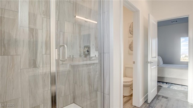 1157 Blossom Point St, Las Vegas, NV 89135 - full bathroom with a stall shower, toilet, visible vents, connected bathroom, and wood finished floors