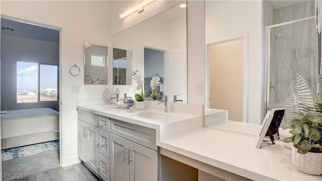 1157 Blossom Point St, Las Vegas, NV 89135 - ensuite bathroom with a stall shower, double vanity, a sink, and wood finished floors