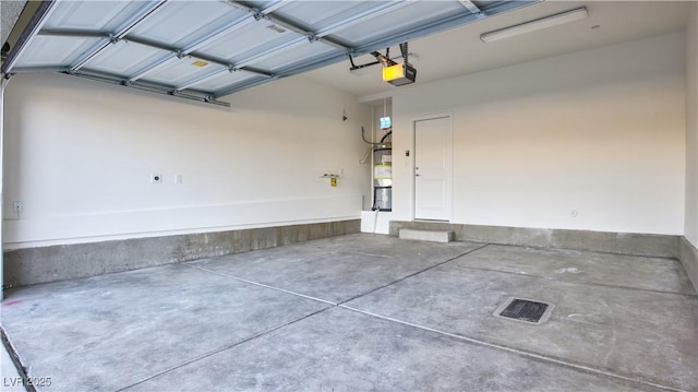 1157 Blossom Point St, Las Vegas, NV 89135 - garage featuring water heater and a garage door opener