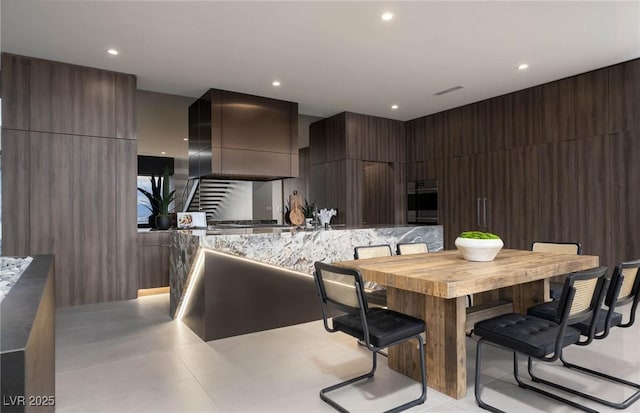 12 Chisel Crest Ct, Henderson, NV 89012 - kitchen featuring wall chimney range hood, oven, recessed lighting, light countertops, and modern cabinets