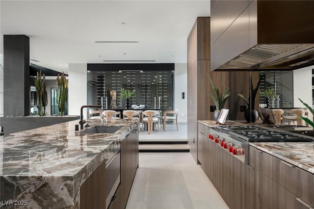 12 Chisel Crest Ct, Henderson, NV 89012 - kitchen with wall chimney range hood, gas cooktop, modern cabinets, and a sink