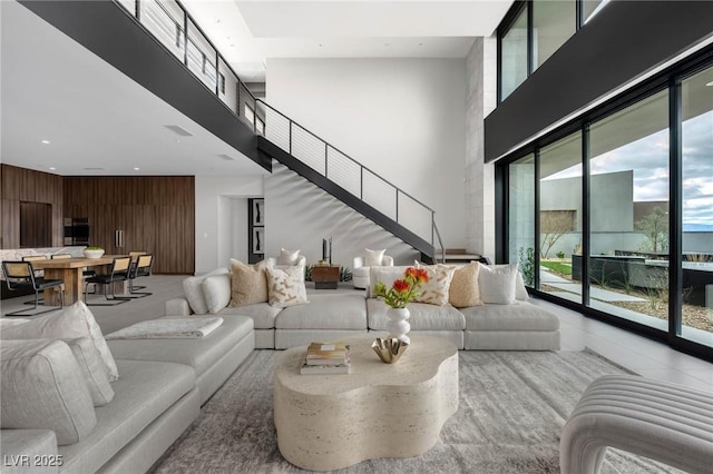 12 Chisel Crest Ct, Henderson, NV 89012 - living area featuring wood walls, visible vents, a high ceiling, and stairs