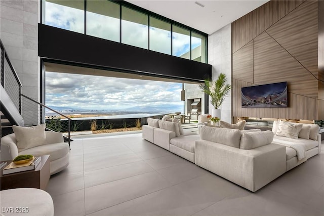12 Chisel Crest Ct, Henderson, NV 89012 - tiled living area featuring expansive windows, a towering ceiling, and a healthy amount of sunlight