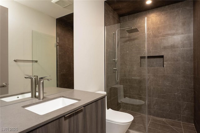 12 Chisel Crest Ct, Henderson, NV 89012 - bathroom featuring toilet, a tile shower, visible vents, vanity, and recessed lighting