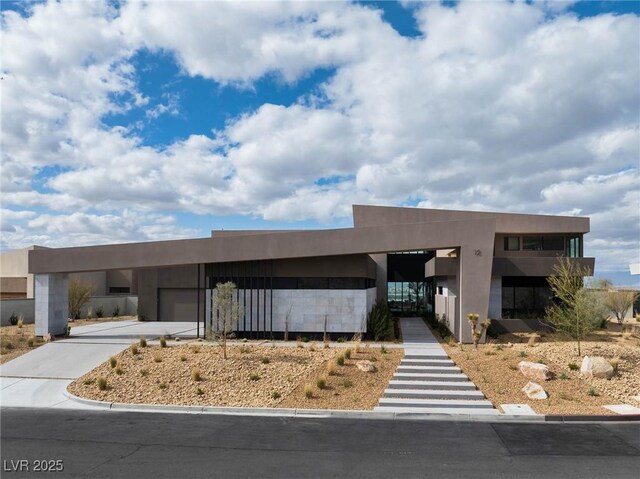 12 Chisel Crest Ct, Henderson, NV 89012 - view of front facade featuring concrete driveway, an attached carport, and stucco siding