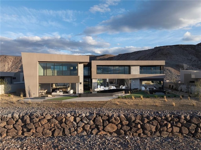 12 Chisel Crest Ct, Henderson, NV 89012 - rear view of house featuring a patio area, an outdoor living space, and a mountain view