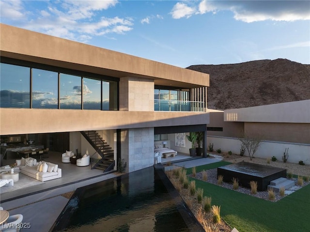 12 Chisel Crest Ct, Henderson, NV 89012 - back of house featuring an outdoor living space, a mountain view, a patio area, stucco siding, and stairway