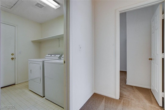 washroom with baseboards, washer and dryer, visible vents, laundry area, and light colored carpet