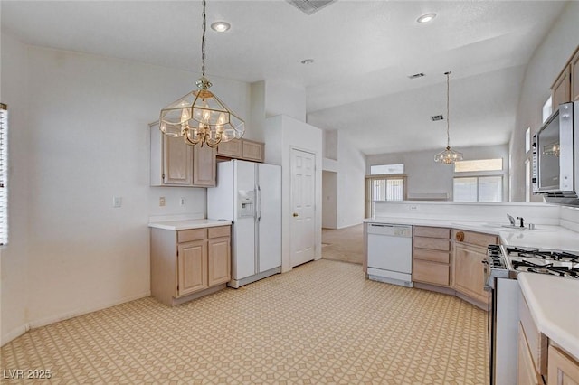 kitchen with a notable chandelier, light countertops, light brown cabinetry, and white appliances
