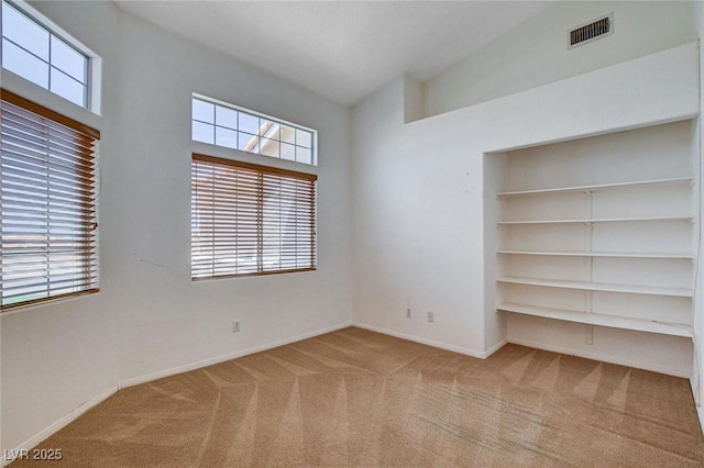 unfurnished bedroom featuring carpet, visible vents, baseboards, and a closet