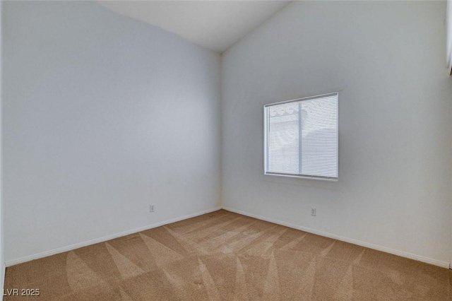 unfurnished room with vaulted ceiling, carpet floors, and baseboards