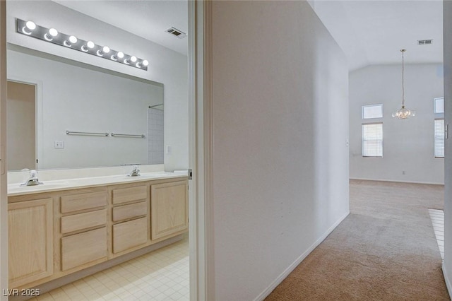 interior space featuring vaulted ceiling, visible vents, and a sink