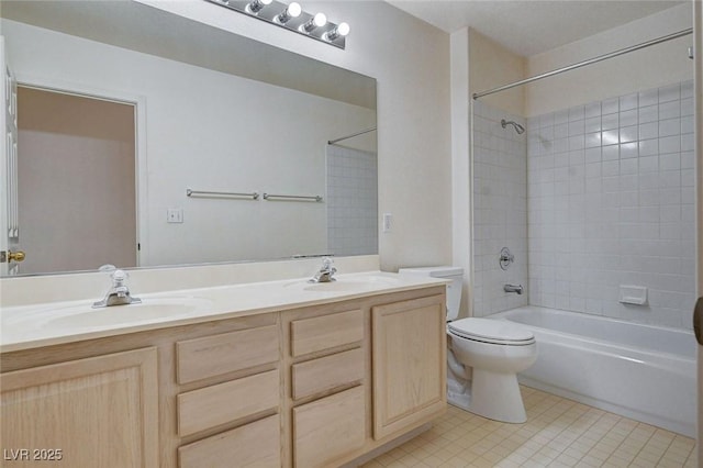 full bath with a sink, tile patterned flooring, toilet, and shower / bathing tub combination