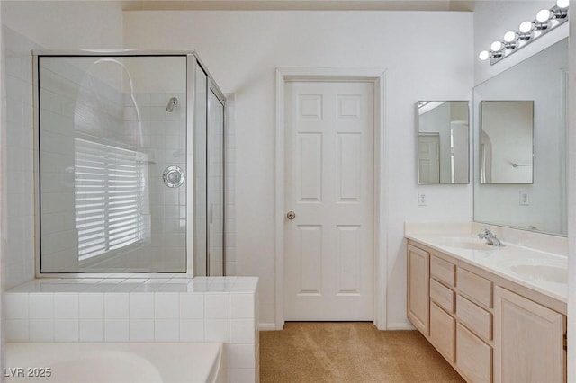 bathroom featuring a shower stall, a bath, double vanity, and a sink
