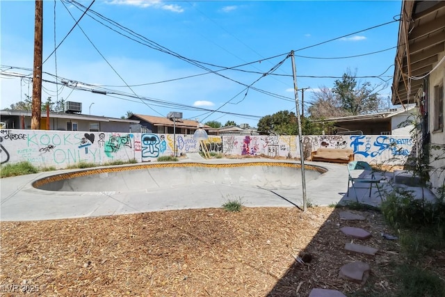 view of yard featuring fence and central AC
