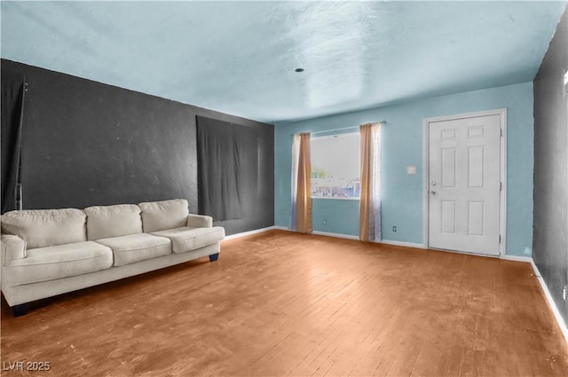 living area featuring hardwood / wood-style flooring and baseboards
