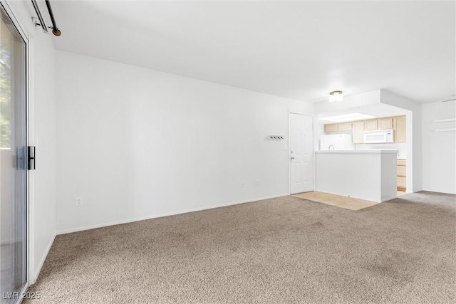 1900 Mountain Hills Ct Unit 203, Las Vegas, NV 89128 - empty room featuring baseboards, plenty of natural light, and light colored carpet
