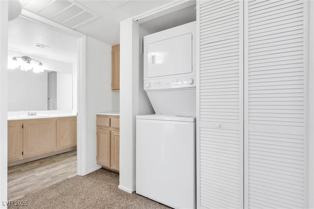 1900 Mountain Hills Ct Unit 203, Las Vegas, NV 89128 - laundry room with a sink, stacked washer and dryer, laundry area, baseboards, and light colored carpet