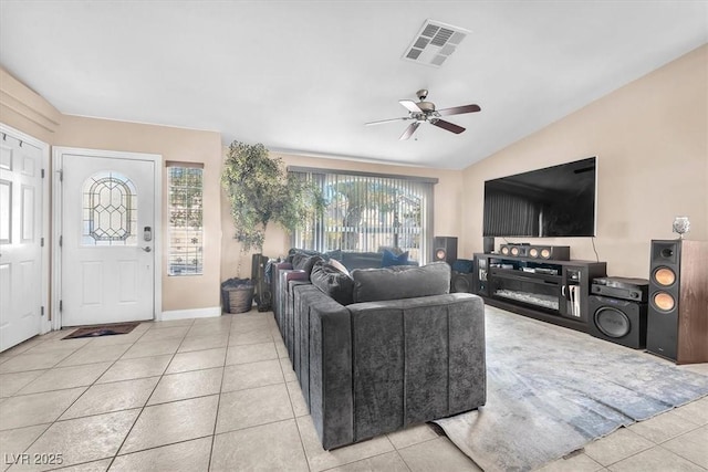 10113 Walhalla Plateau Ct, Las Vegas, NV 89148 - living area with vaulted ceiling, light tile patterned flooring, a ceiling fan, and baseboards