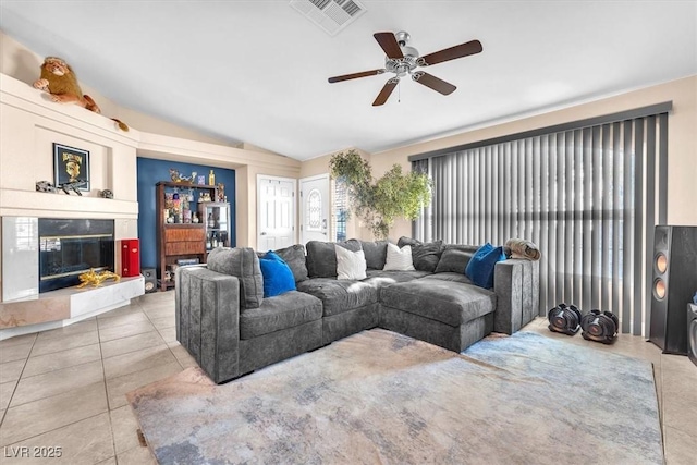 10113 Walhalla Plateau Ct, Las Vegas, NV 89148 - tiled living area featuring lofted ceiling, ceiling fan, and a glass covered fireplace