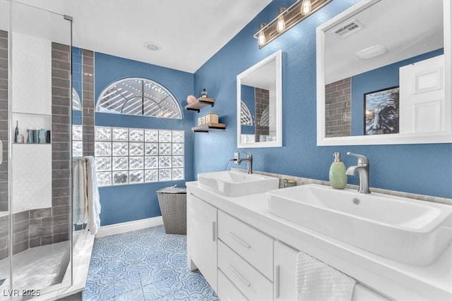 10113 Walhalla Plateau Ct, Las Vegas, NV 89148 - bathroom featuring a stall shower, double vanity, and tile patterned flooring