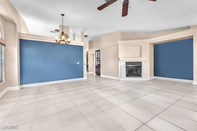 10113 Walhalla Plateau Ct, Las Vegas, NV 89148 - unfurnished living room featuring a ceiling fan, a fireplace with raised hearth, light tile patterned floors, a chandelier, and baseboards