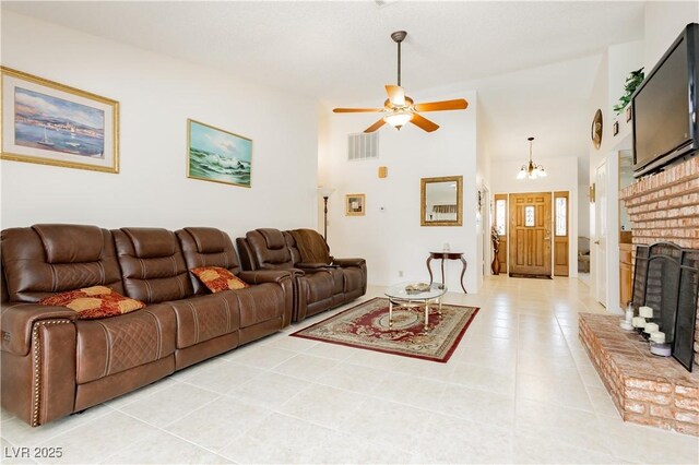 1528 Tonada Way, Las Vegas, NV 89117 - living room with light tile patterned floors, a ceiling fan, a fireplace, and a chandelier
