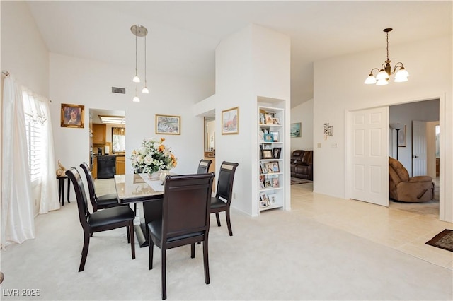 1528 Tonada Way, Las Vegas, NV 89117 - dining room featuring a chandelier, light colored carpet, and high vaulted ceiling
