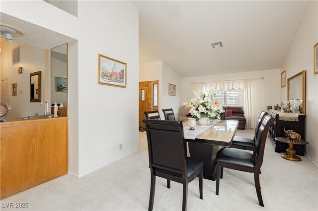 1528 Tonada Way, Las Vegas, NV 89117 - dining room featuring light carpet, vaulted ceiling, and baseboards