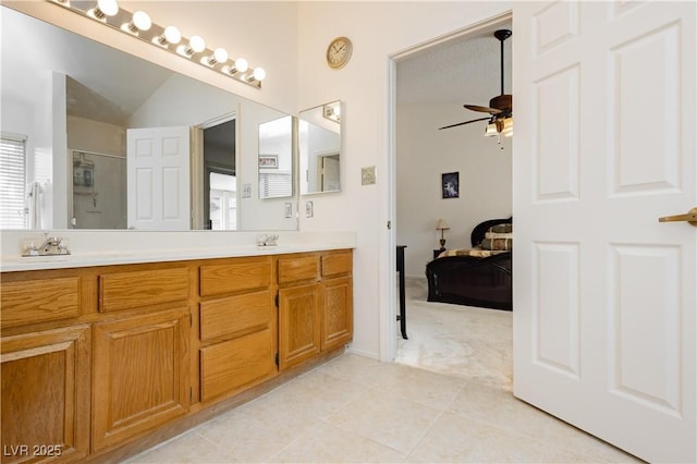 1528 Tonada Way, Las Vegas, NV 89117 - ensuite bathroom featuring a ceiling fan, double vanity, tile patterned floors, and a shower with shower door