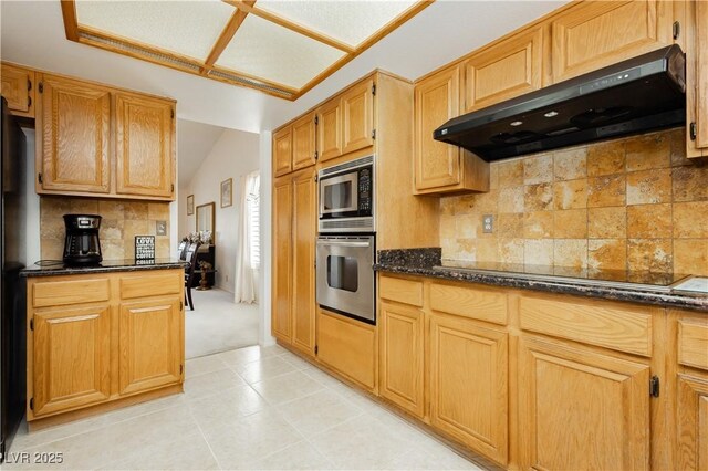 1528 Tonada Way, Las Vegas, NV 89117 - kitchen with stainless steel appliances, extractor fan, decorative backsplash, vaulted ceiling, and dark stone countertops