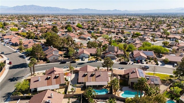 1528 Tonada Way, Las Vegas, NV 89117 - aerial perspective of suburban area featuring a pool area and a mountain backdrop