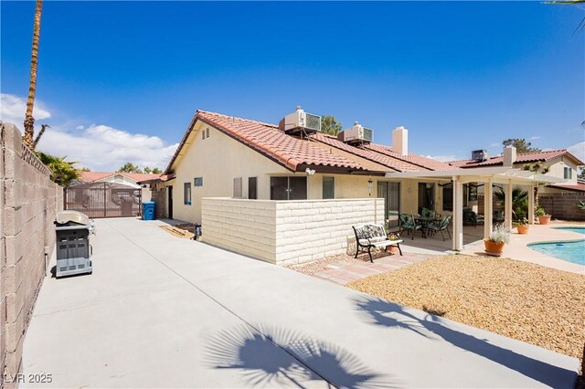 1528 Tonada Way, Las Vegas, NV 89117 - rear view of property with stucco siding, a fenced backyard, a gate, a patio, and a tiled roof