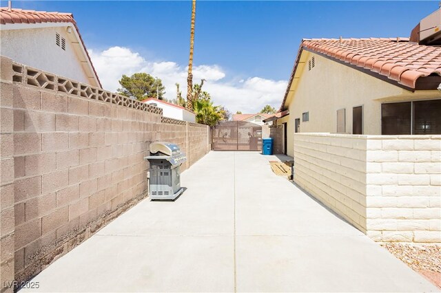 1528 Tonada Way, Las Vegas, NV 89117 - fenced backyard featuring a patio, a grill, and a gate