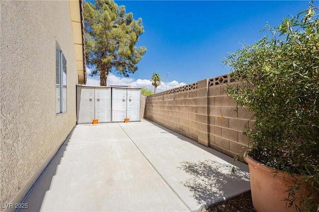 view of patio / terrace with fence and mail area