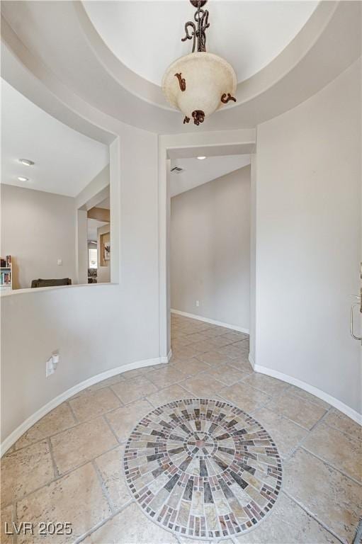 empty room with baseboards, stone tile floors, and recessed lighting