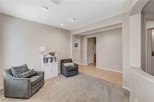 living area with carpet, tile patterned floors, baseboards, and recessed lighting